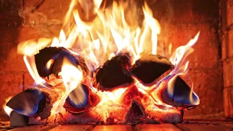 Close-up firewood burning with a bright flame in a red brick fireplace Stock Footage 163989588