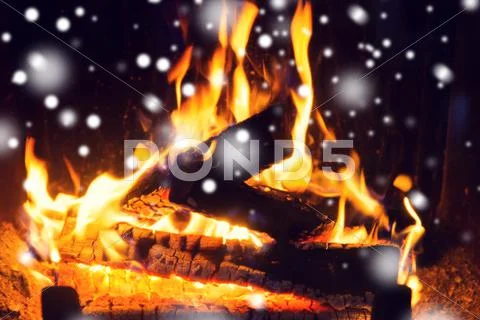 Close up of firewood burning in fireplace and snow Stock Photos