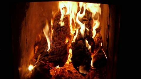 Close up of firewood burning in fires. A log fire crackling in the fireplace. Video stock 130692412