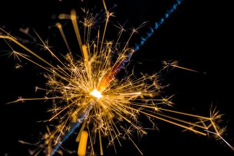 Close-up of firework sparkler burning on black background, congratulation Foto stock