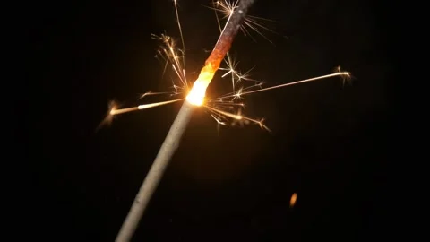 Close-up of firework sparkler burning. Fireworks burn on a black background. Stock Footage 165092773