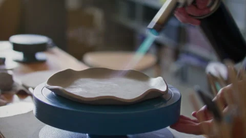Close-Up of Firing Ceramic Dish with Handheld Blowtorch in Pottery Workshop Stock Footage 319226772