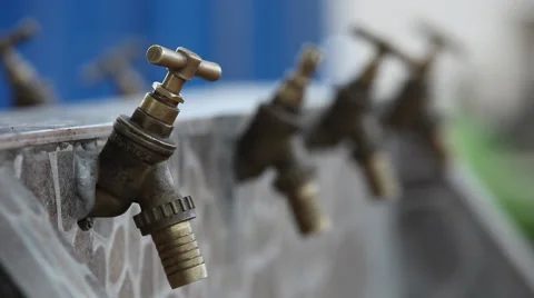 CLOSE UP ON FIRST OF FOUR WATER FAUCETS Stock Footage 60512583