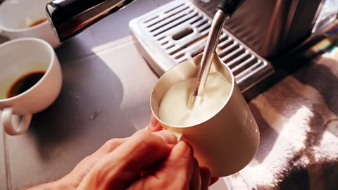 Close Up First Person View Frothing Milk In Metal Pitcher With Steam Wand In Slo Stock Footage 331025508