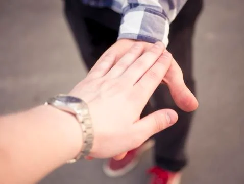 Close up first person view of two persons giving high five 스톡 사진