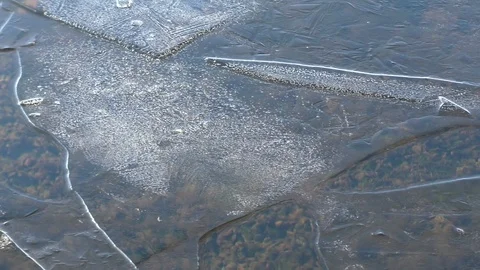 Close up of first thin autumn ice drifting on river water surface Stock Footage 120644375