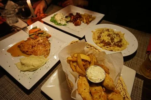 Close up Fish and chips with cheesy pasta and pork steak Stock Photos