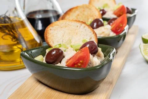 Close-up of fish roe salad served in small green bowls with toasted bread Foto stock