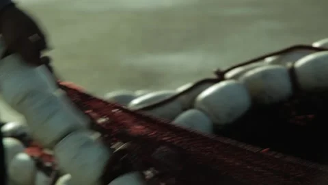 Close up , fishermen manually pulls their net out of the ocean Stock Footage 156673507