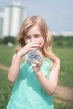Close-Up Of five years old pretty Girl Drinking Water Foto stock