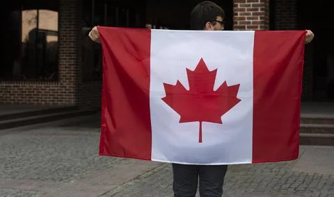 Close up of the flag of Canada in man hands Foto stock