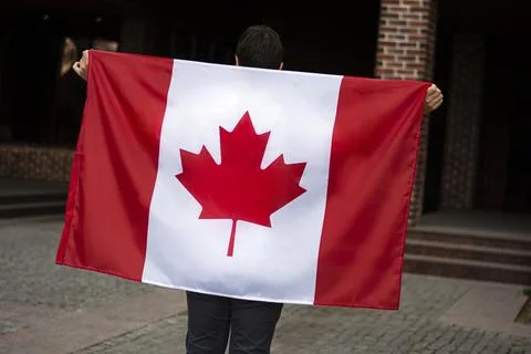 Close up of the flag of Canada in man hands Stock Photos