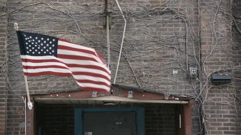 Close up of Flag waving on industrial brick building Stock Footage 89945050