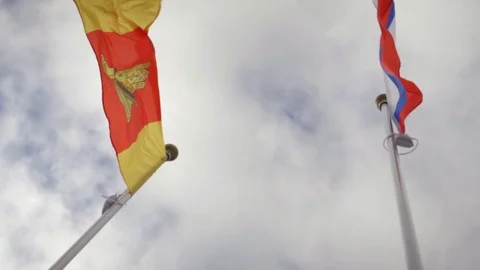 Close-up of flags against the sky. Slow-motion images. The wind blows Stock Footage 125557529
