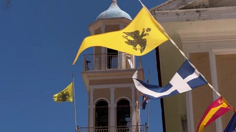 Close-Up of Flags and Banners Waving with Church Bell Tower 4K Stock Footage 316836002