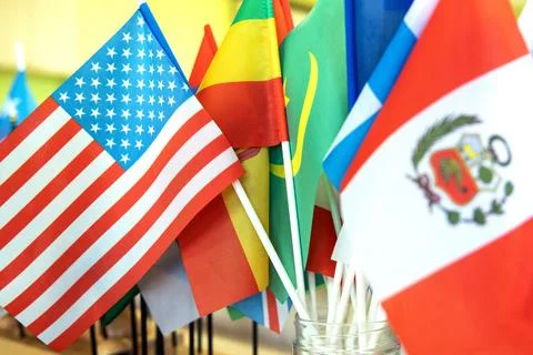 Close-up on the flags of Peru and the USA against the background of other flags Stock Photos