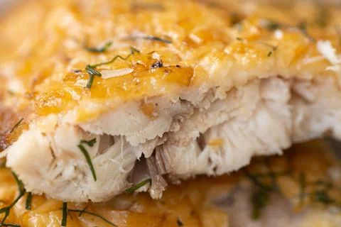 Close-up of flaky baked white fish topped. Stock Photos