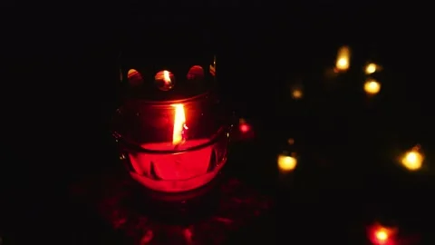 Close-up of the flame of the candle burning on the grave. Stock Footage 233970306