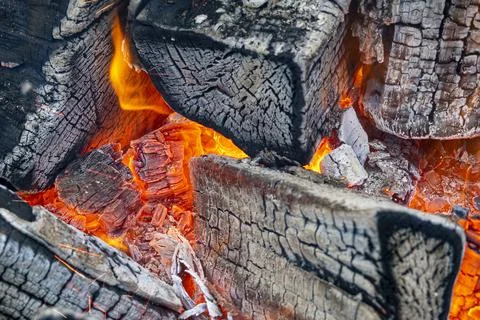 Close-up of flame, fire with ash, logs, wood. Selective focus Stock Photos