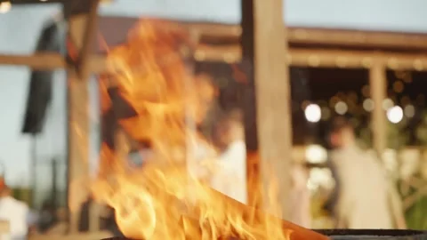 A close-up of the flame of a fire or bonfire that is burning at a backyard party Stock Footage 259156874