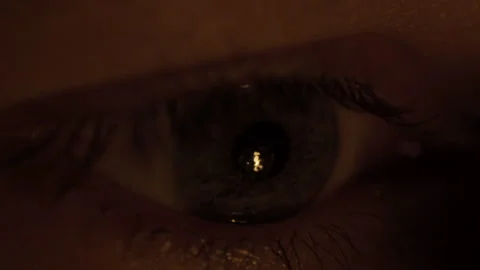Close-up the flame of a fire is reflected in the spectator`s male eye Stock Footage 303574424