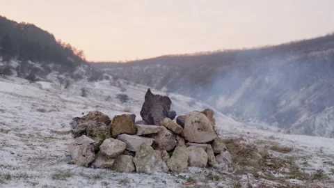 Close up of a flame that goes out on the snow near the mountain stream. Stock Footage 146981203