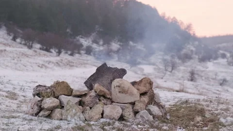 Close up of a flame that goes out on the snow near the mountain stream. Stock Footage 147137689