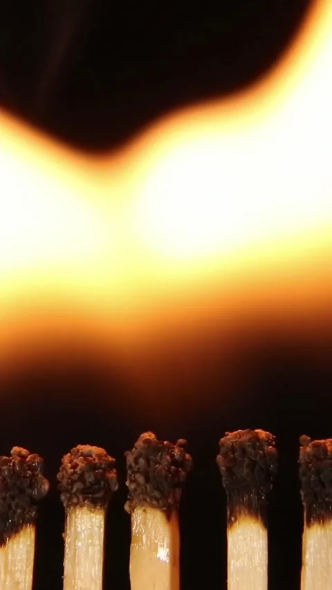 Close-up flames creating mesmerizing golden wave patterns against dark Video stock 309853813