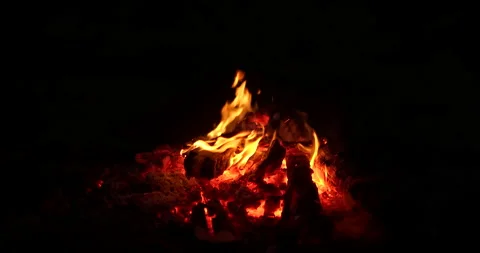 Close-up, flames from fire. Night bonfire, logs are on fire, sparks fly. 4k Stock Footage 144644452