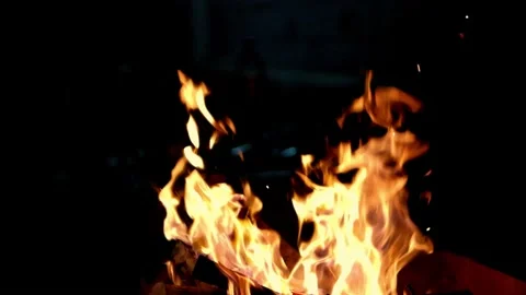 Close-up, flames from fire. Night bonfire, logs are on fire, sparks fly. 4k Stock Footage 230050684