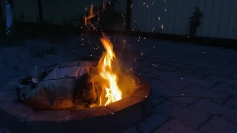 Close-up, flames from fire. Night bonfire, logs are on fire, sparks fly. 4k Stock Footage 243486338