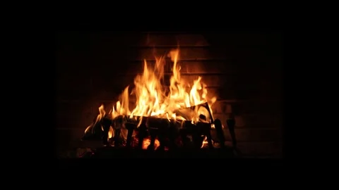 Close-up, flames from the fireplace fire. The logs are burning, sparks are Stock Footage 262639421