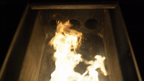 Close-up of flames inside the pellet stove, alternative biofuel burning in stove Stock Footage 129487057