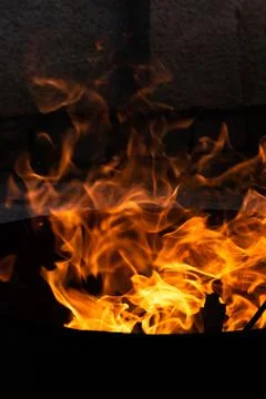 Close up of the flames of a small bonfire burning outdoors, campfire in summe Stock Photos