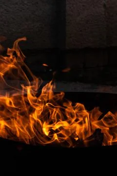 Close up of the flames of a small bonfire burning outdoors, campfire in summe Stock Photos