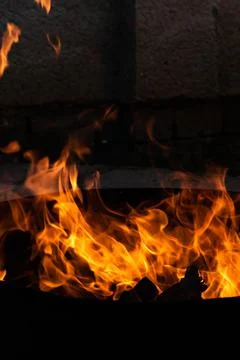 Close up of the flames of a small bonfire burning outdoors, campfire in summe Stock Photos