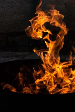 Close up of the flames of a small bonfire burning outdoors, campfire in summe Stock Photos
