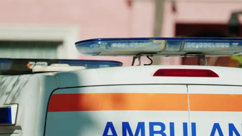 Close up of flashing blue emergency lights on top of an ambulance vehicle, Video stock 336780578