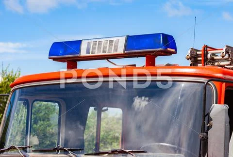 Close-up of the Flashing Blue Siren Light on roof of red firetruck Stock Photos
