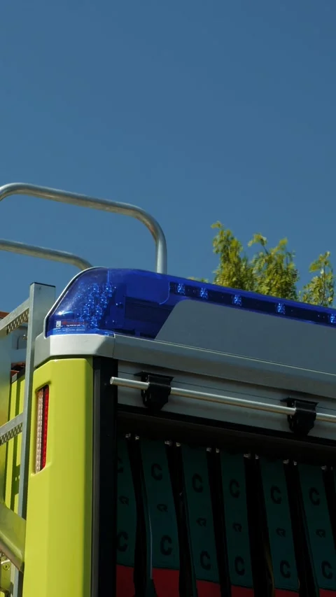 Close up of flashing emergency blue warning lights on fire truck. Vertical video Stock Footage 317692908