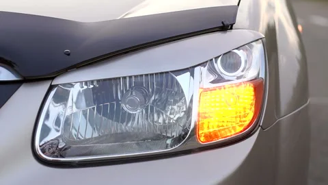 Close-up of the flashing yellow front light on the car. Emergency. Slow motion. Stock Footage 115152856