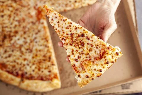 Close up flat lay image of a caucasian woman holding a slice of fresh cheese  Stock-Fotos