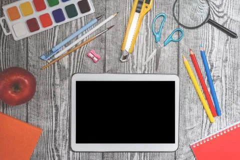 Close up flat lay with many school supplies and apple on wooden background. Stock Photos