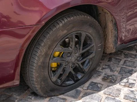 Close-up of a flat tire on a car. Problems on the road. Stock Photos