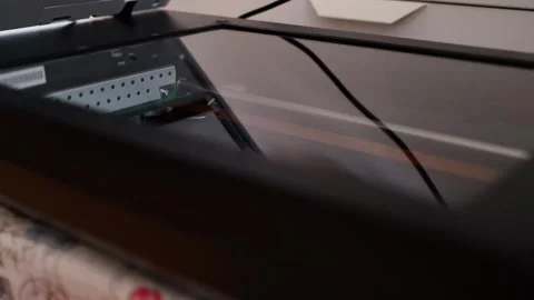 Close-up of a flatbed scanner lid partially open showing cables and Stock Footage 292590410
