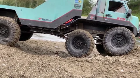 Close up flatbed towing truck going on wet bumpy sand. Stock Footage 207401936