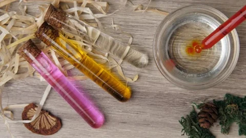 A close-up of a flatlay as three bottles of liquid lie on a wooden table and Stock Footage 149527803