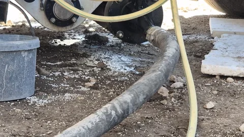 Close Up of Flexible Concrete Hose Pulsing as Lightweight Concrete is Pumped Stock Footage 340562805