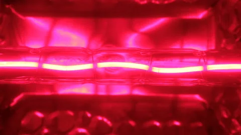 Close-up, flicker of a red tungsten spiral of a halogen bulb. 動画素材 95743933