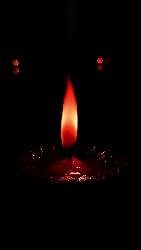 Close-up of a flickering diya glowing warmly against a dark, serene background. Stock Footage 294701516